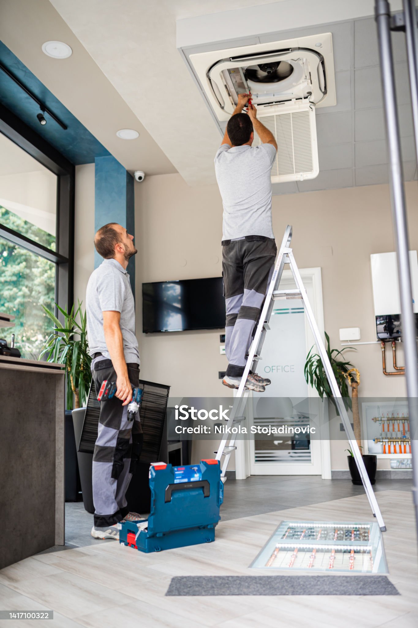 workers install air conditioning workers